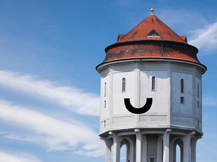 Man sieht den Emder Wasserturm mit einem Smiley Lächeln